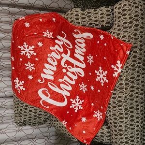 Merry Christmas lap blanket red base with white snowflakes and words. NWT